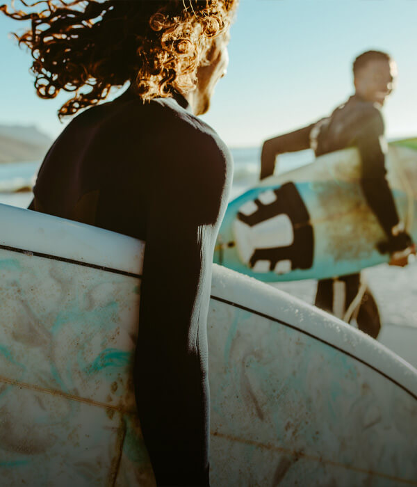 Group of friends surfing together in the ocean.